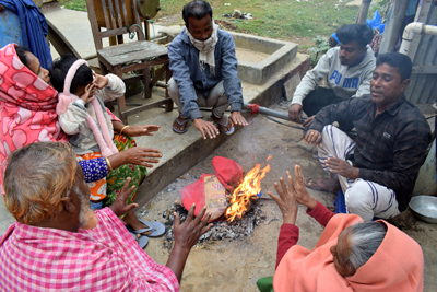 To beat the cold waves across the state, a group of people heating their hands through fire woods in Agartala on December 26. 
